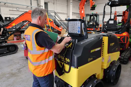 Matt Robins Parts Manager with a BOMAG BMP8500 trench roller in the workshop