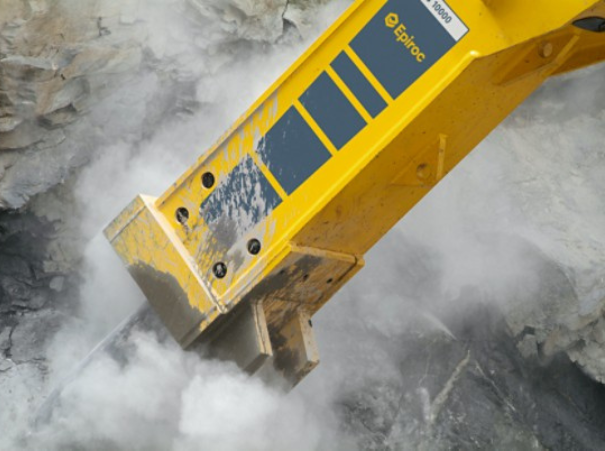 epiroc breaker breaking some concrete with a dust cloud