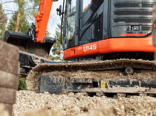 Kubota U145 left side, view from bottom angle, close on tracks, working on site