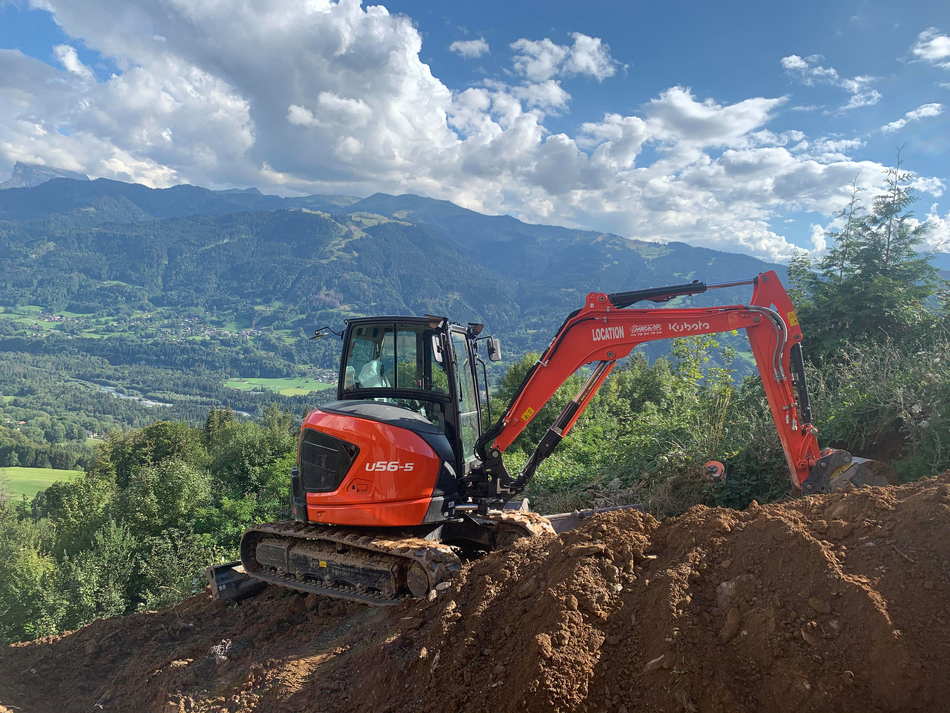 Kubota U56-5 in the mountains working on a hillside digging