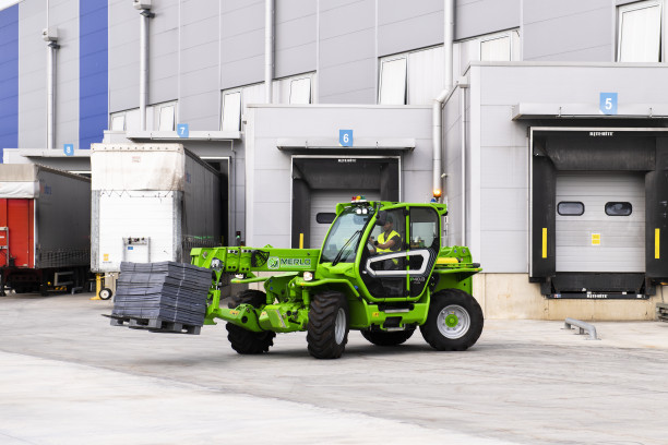 Merlo P40.13 stabilised telehandler carrying a pallet of materials on site