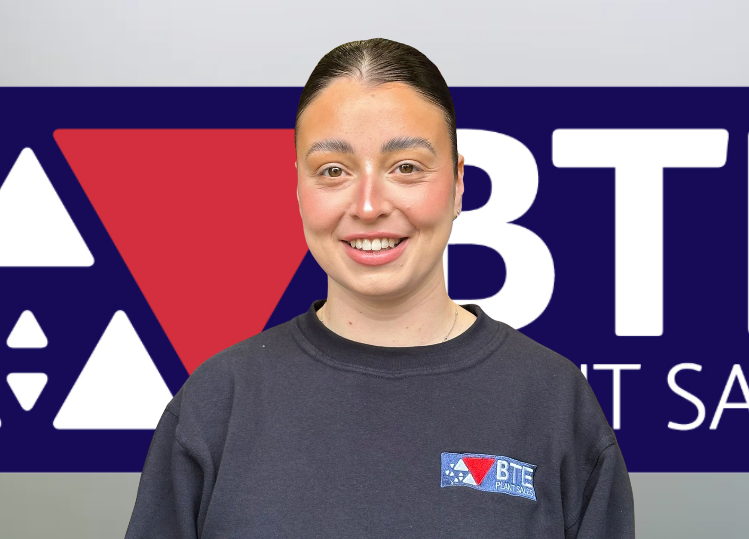 bte's key account support, megan fisher smiling with a bte logo in the background