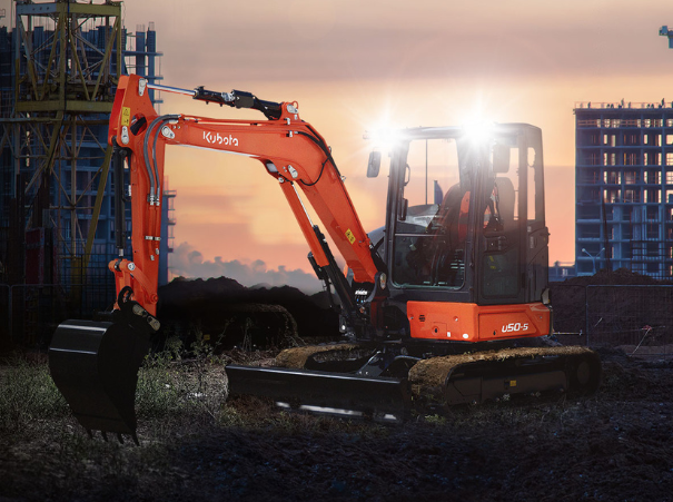 Kubota U50-5 excavator at dusk with headlights on Kubota U50-5 excavator at dusk with headlights on
