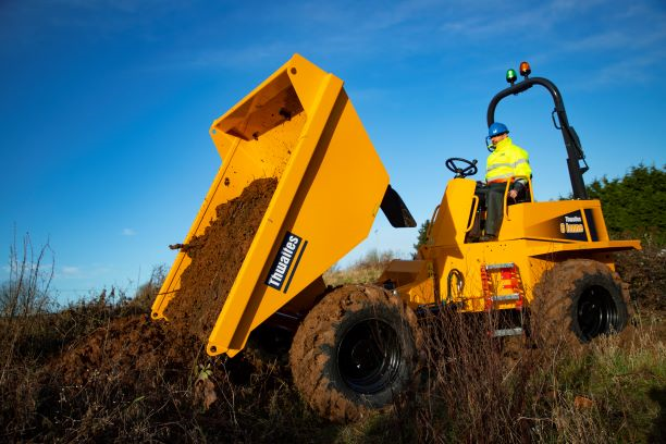 Thwaites 6 Tonne Front Tip working on site. Skip is full and tipping mud out into a mound.