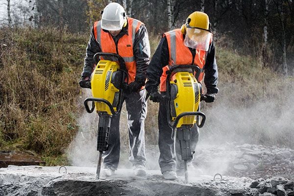 two workers using the atlas copco Cobra breakers