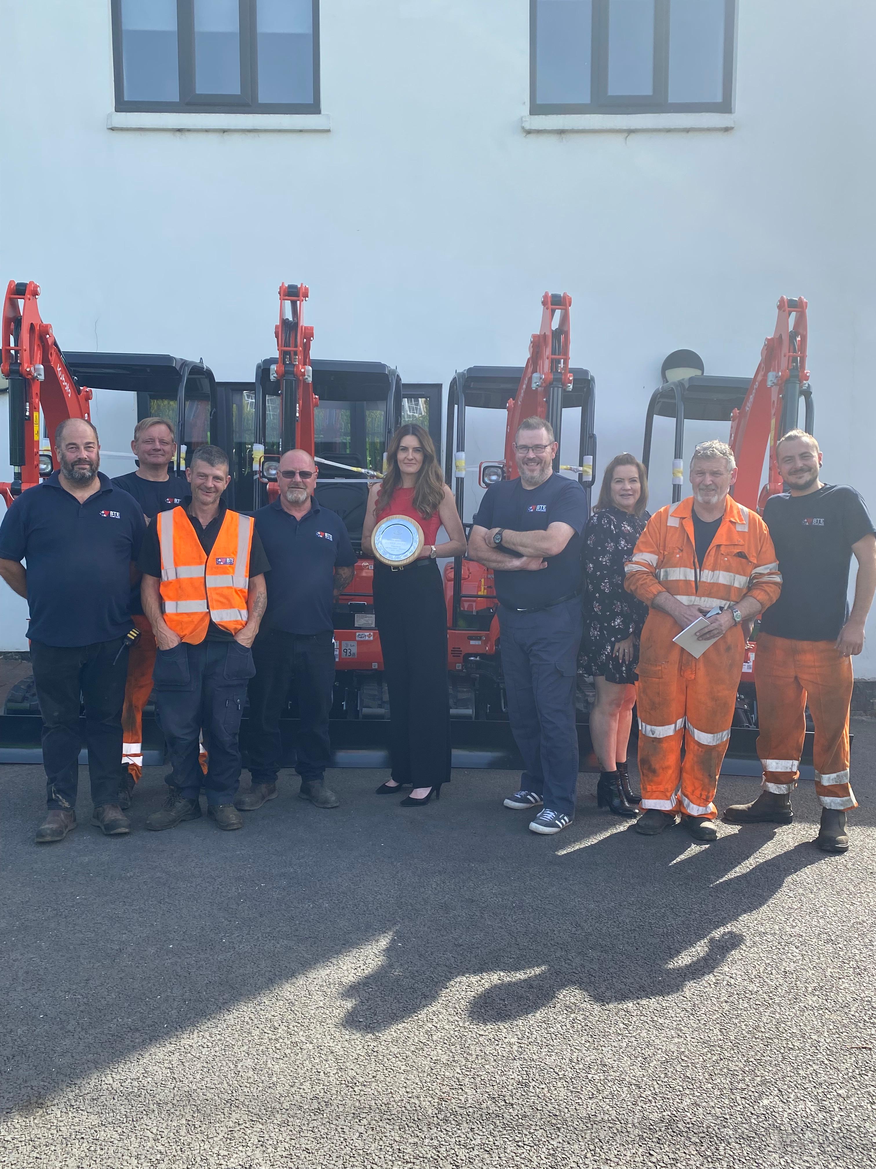 Rebecca Bryson and the Service team receiving the silver service award from Kubota