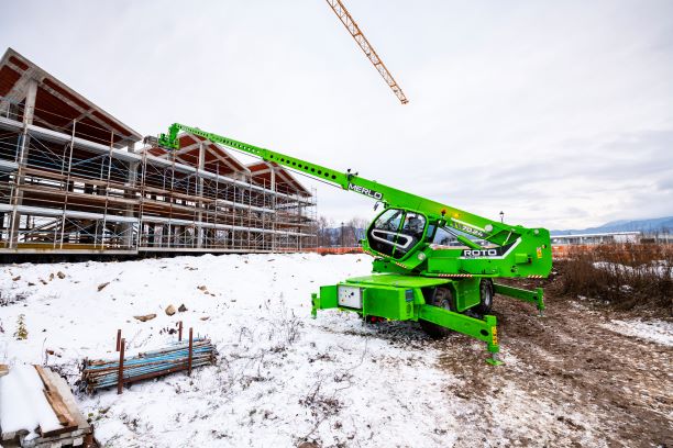 Merlo ROTO70.24S PLUS working on site with boom extended, lifting materials