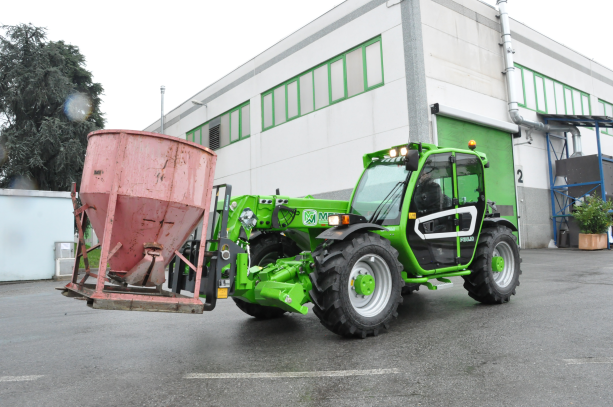 Merlo P30.10, stabilised telehandler carry a pallet on site. 