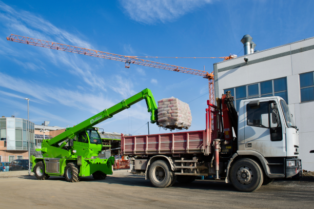 Merlo ROTO40.16 S rotating telehandler on site loading up a truck.